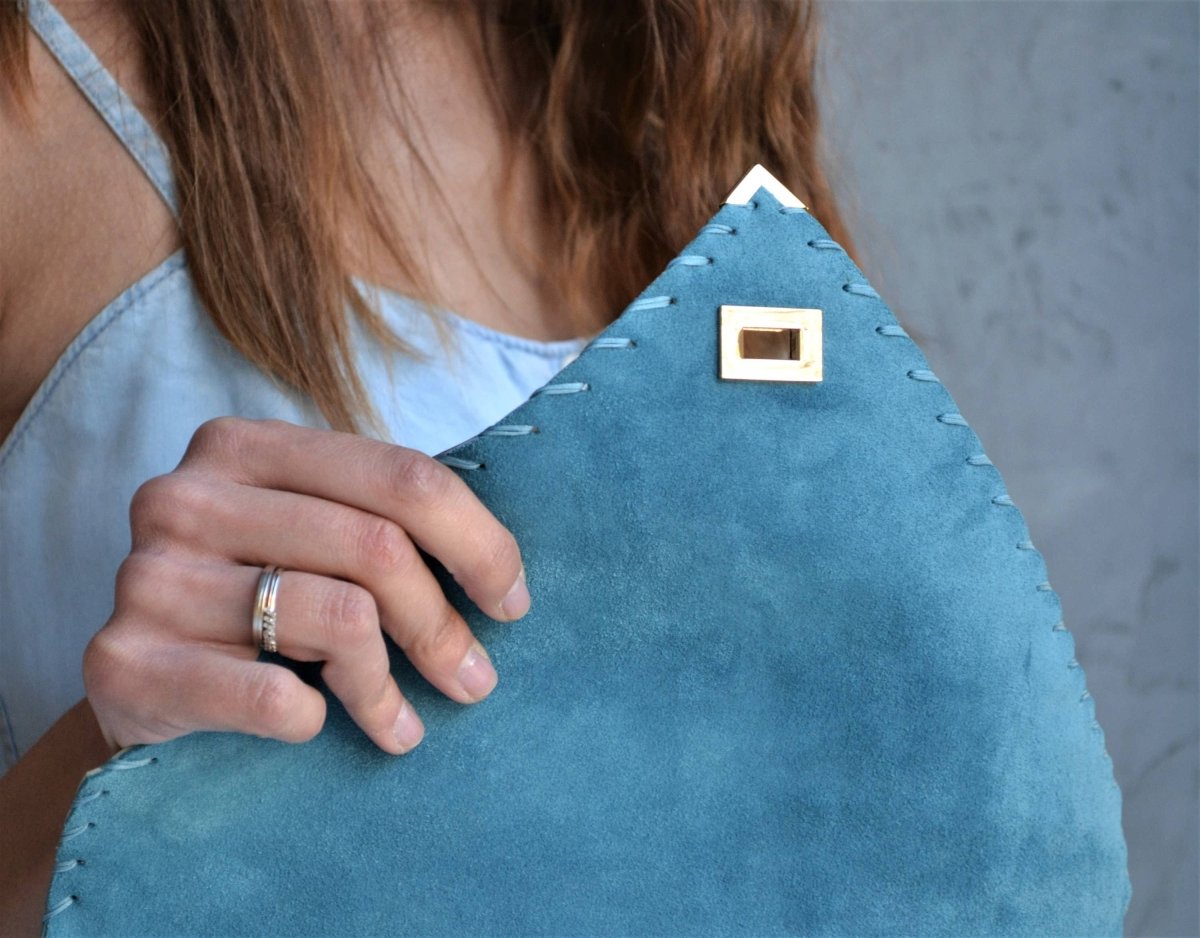 Suede clutch in teal blue: Gold hardwareANA KOUTSIACCESS