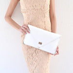 Symmetria leather clutch in white: GoldANA KOUTSIACCESS