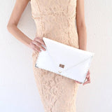 Symmetria leather clutch in white: GoldANA KOUTSIACCESS