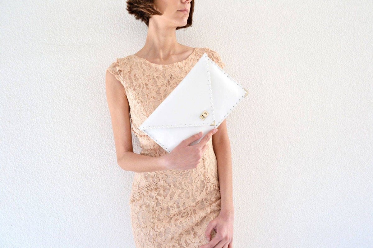 Symmetria leather clutch in white: GoldANA KOUTSIACCESS