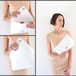 Symmetria leather clutch in white: GoldANA KOUTSIACCESS