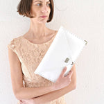 Symmetria leather clutch in white: GoldANA KOUTSIACCESS